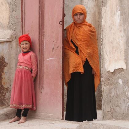 Photo of Somaya standing in a doorway in Herat, Afghanistan.